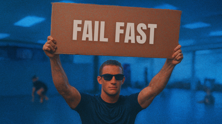 A person cool looking flaunting a board that has Fail fast text on it