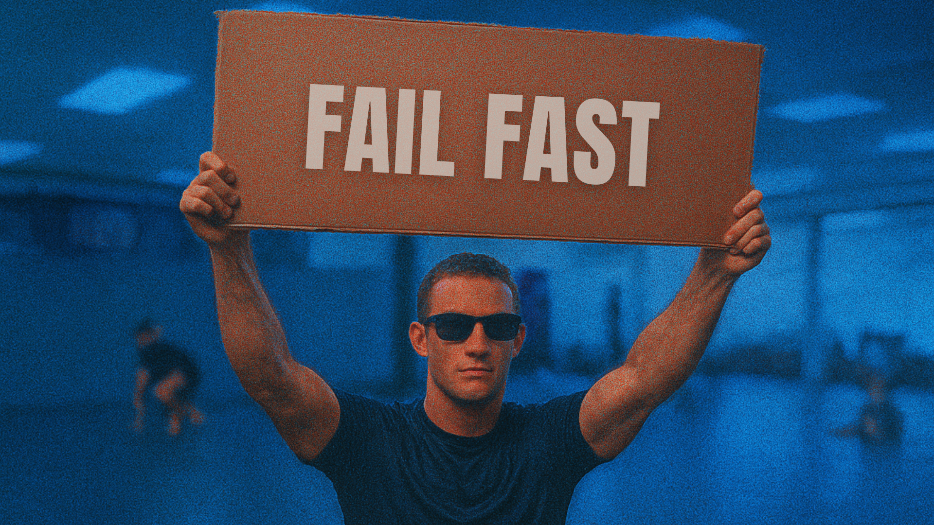 A person cool looking flaunting a board that has Fail fast text on it